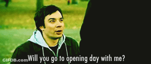 A Man In A Hoodie Is Talking To Another Man In A Park And Asking If He Will Go To Opening Day With Him . GIF