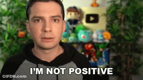 A Man In A Hoodie Says I 'M Not Positive In Front Of A Shelf Full Of Stuffed Animals . GIF