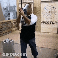 A Man In A Horse Mask Is Holding An Axe GIF