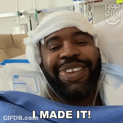 A Man In A Hospital Bed Has A Bandage On His Head And Says I Made It GIF