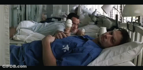 A Man In A Hospital Bed Is Wearing A Shirt That Says Us GIF