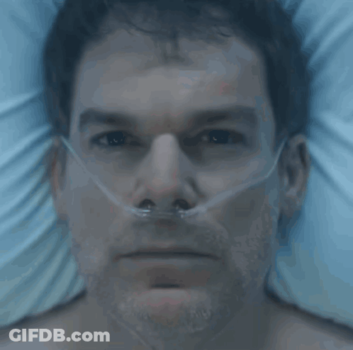 A Man In A Hospital Bed With An Oxygen Mask On His Nose GIF