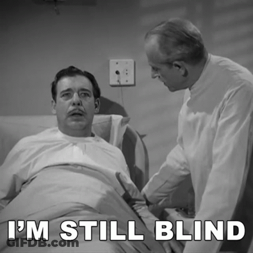 A Man In A Hospital Bed With The Words I 'M Still Blind GIF