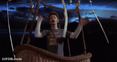 A Man In A Hot Air Balloon Wearing A Shirt That Says ' I 'M A Cowboy ' On It GIF
