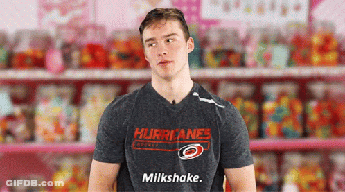 A Man In A Hurricanes Shirt Says Milkshake In Front Of Candy GIF