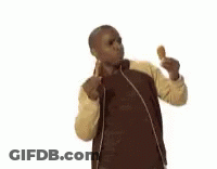 A Man In A Jacket Is Eating A Fried Chicken . GIF