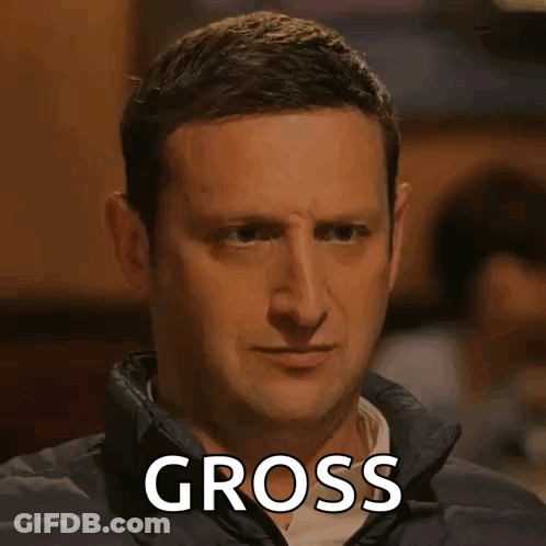 A Man In A Jacket Is Making A Funny Face With The Word Gross Written On His Face . GIF