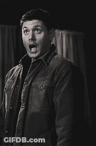 A Man In A Jacket Is Making A Surprised Face GIF