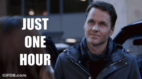A Man In A Jacket Stands In Front Of A Sign That Says " Just One Hour " GIF