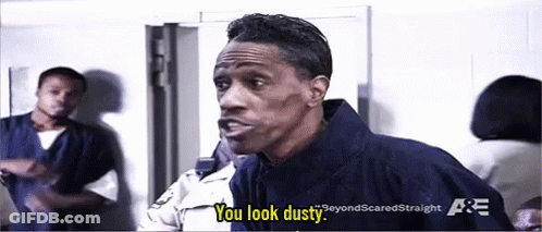 A Man In A Jail Cell Is Talking To A Police Officer And Saying You Look Dusty . GIF