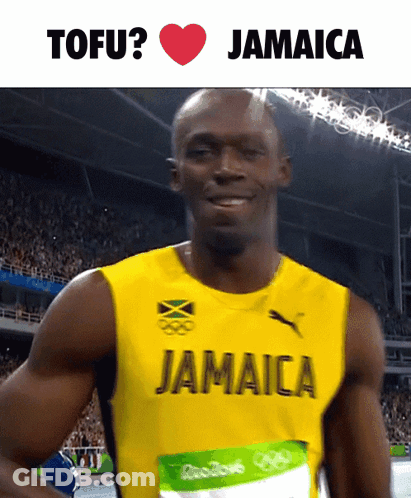 A Man In A Jamaica Jersey Is Smiling GIF