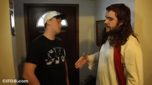 A Man In A Jesus Costume Talks To Another Man In A Black Shirt GIF