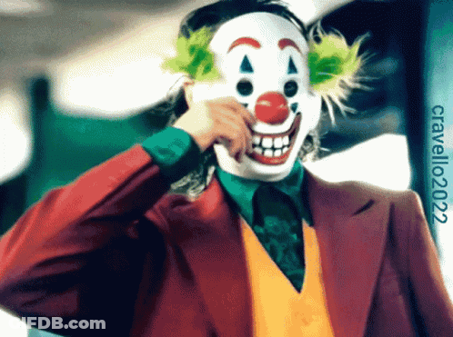 A Man In A Joker Costume Is Making A Face With His Hand GIF