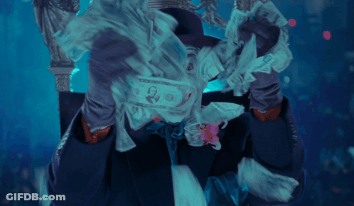 A Man In A Joker Costume With A Flower In His Tie GIF