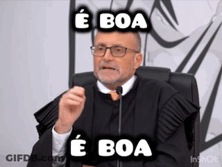 A Man In A Judge 'S Robe Is Sitting In Front Of A Microphone And Making A Funny Face . GIF
