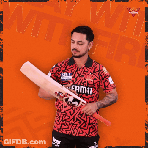 A Man In A Kent Shirt Holds A Cricket Bat In Front Of An Orange Background GIF