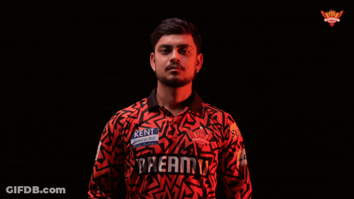 A Man In A Kent Shirt Is Holding A Bat GIF