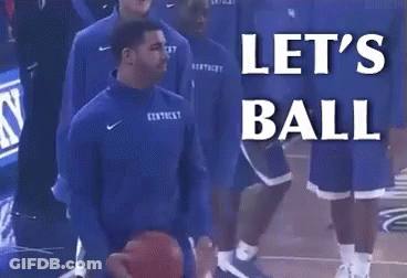 A Man In A Kentucky Jersey Is Holding A Basketball In Front Of A Sign That Says Let 'S Ball GIF