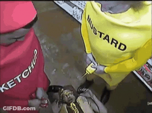 A Man In A Ketchup Costume And A Man In A Mustard Costume Are Holding A Hot Dog . GIF