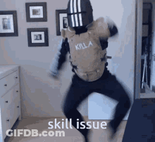 A Man In A Killa Vest Is Jumping In The Air GIF