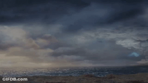 A Man In A Kilt Is Standing In Front Of A Stormy Ocean GIF