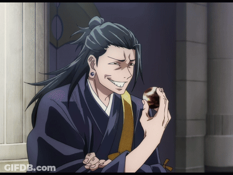 A Man In A Kimono Is Holding Something In His Hand GIF