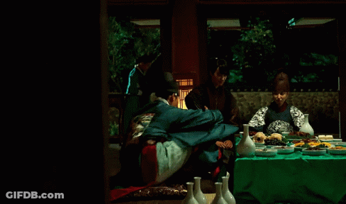 A Man In A Kimono Is Hugging Another Man In A Blue Jacket GIF