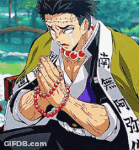 A Man In A Kimono Is Praying With His Hands Folded . GIF