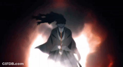 A Man In A Kimono Is Standing In A Dark Room With A Sword In His Hand . GIF