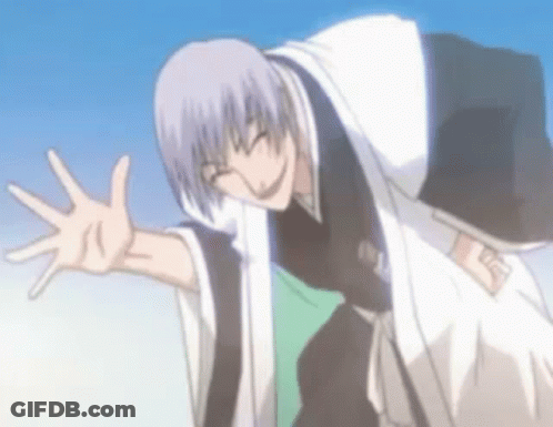 A Man In A Kimono Is Waving His Hand In The Air . GIF