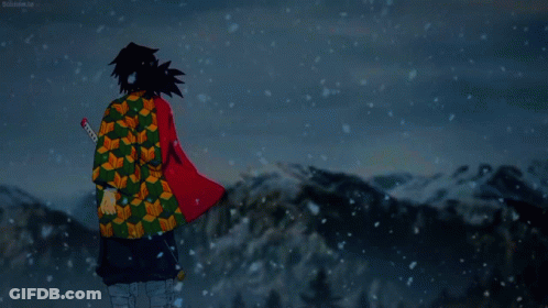 A Man In A Kimono Stands In The Snow With A Sword In His Hand GIF