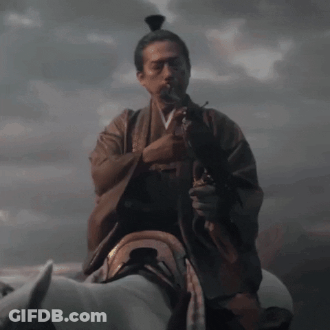 A Man In A Kimono With A Sword In His Hand GIF