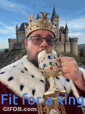 A Man In A King Costume Drinking From A Goblet With The Words Fit For A King Written Below Him GIF
