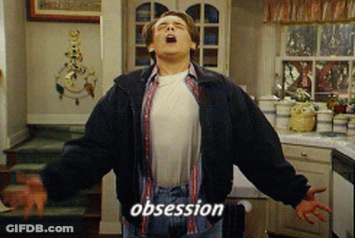 A Man In A Kitchen With His Mouth Open And The Word Obsession On His Chest GIF