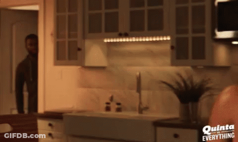 A Man In A Kitchen With Quinta Everything Written On The Bottom GIF