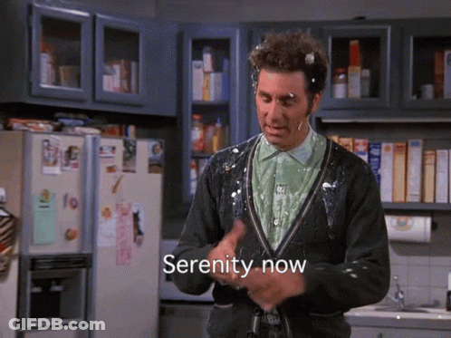 A Man In A Kitchen With Serenity Now Written In The Corner GIF