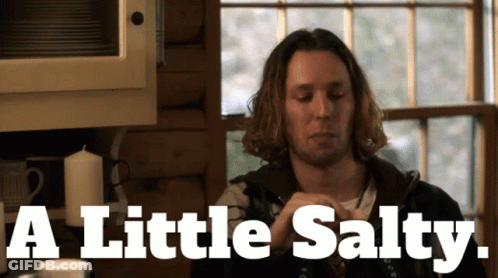 A Man In A Kitchen With The Words " A Little Salty " On The Bottom GIF