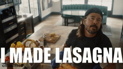 A Man In A Kitchen With The Words " I Made Lasagna " Behind Him GIF