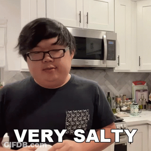 A Man In A Kitchen With The Words Very Salty On His Shirt GIF