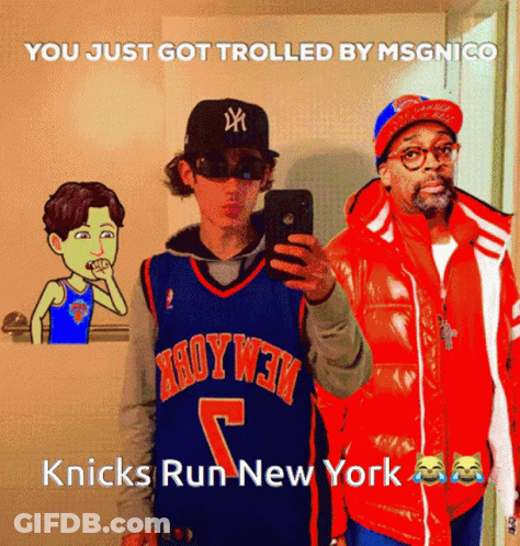 A Man In A Knicks Jersey Takes A Selfie With A Man In An Orange Jacket GIF