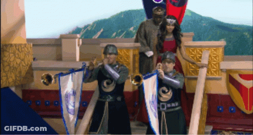 A Man In A Knight Costume Is Playing A Trumpet In Front Of A Woman In A Red Dress GIF