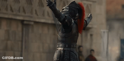A Man In A Knight 'S Armor Has His Arms Outstretched In The Air GIF