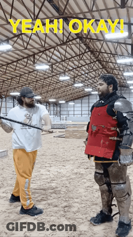 A Man In A Knight 'S Armor Is Standing Next To Another Man In A White Shirt That Says Yeah GIF