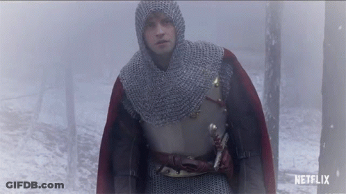 A Man In A Knight 'S Armor Is Walking Through A Foggy Forest With A Netflix Logo Behind Him GIF