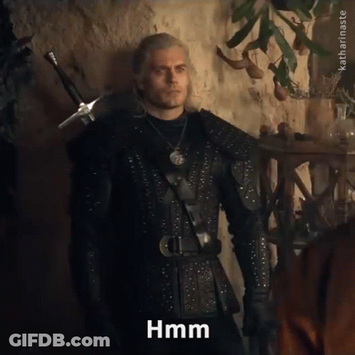 A Man In A Knight 'S Outfit Is Standing In Front Of A Wall And Says Hmm GIF