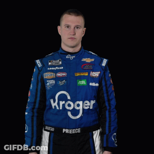 A Man In A Kroger Racing Suit Is Standing With His Hands Outstretched GIF