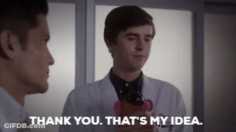 A Man In A Lab Coat Is Holding A Cell Phone And Talking To Another Man In A Hospital Room . GIF