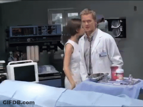A Man In A Lab Coat Is Listening To A Woman With A Stethoscope GIF