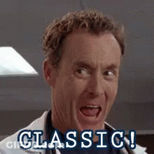 A Man In A Lab Coat Is Smiling And The Words Classic Are Visible Behind Him . GIF