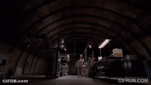 A Man In A Lab Coat Is Touching A Metal Object With The Website Gifrun.com Visible Behind Him GIF